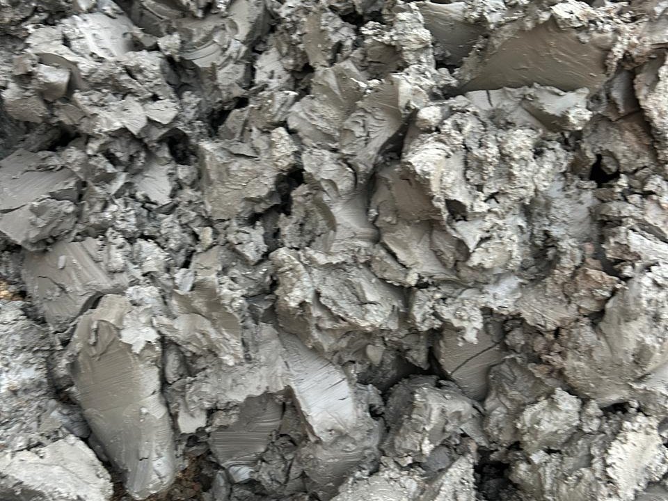 A heap of sticky grey clay cuttings