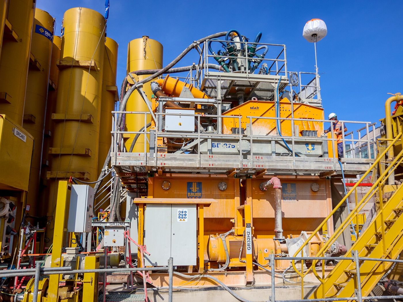 A bentonite slurry plant with silos on a construction site