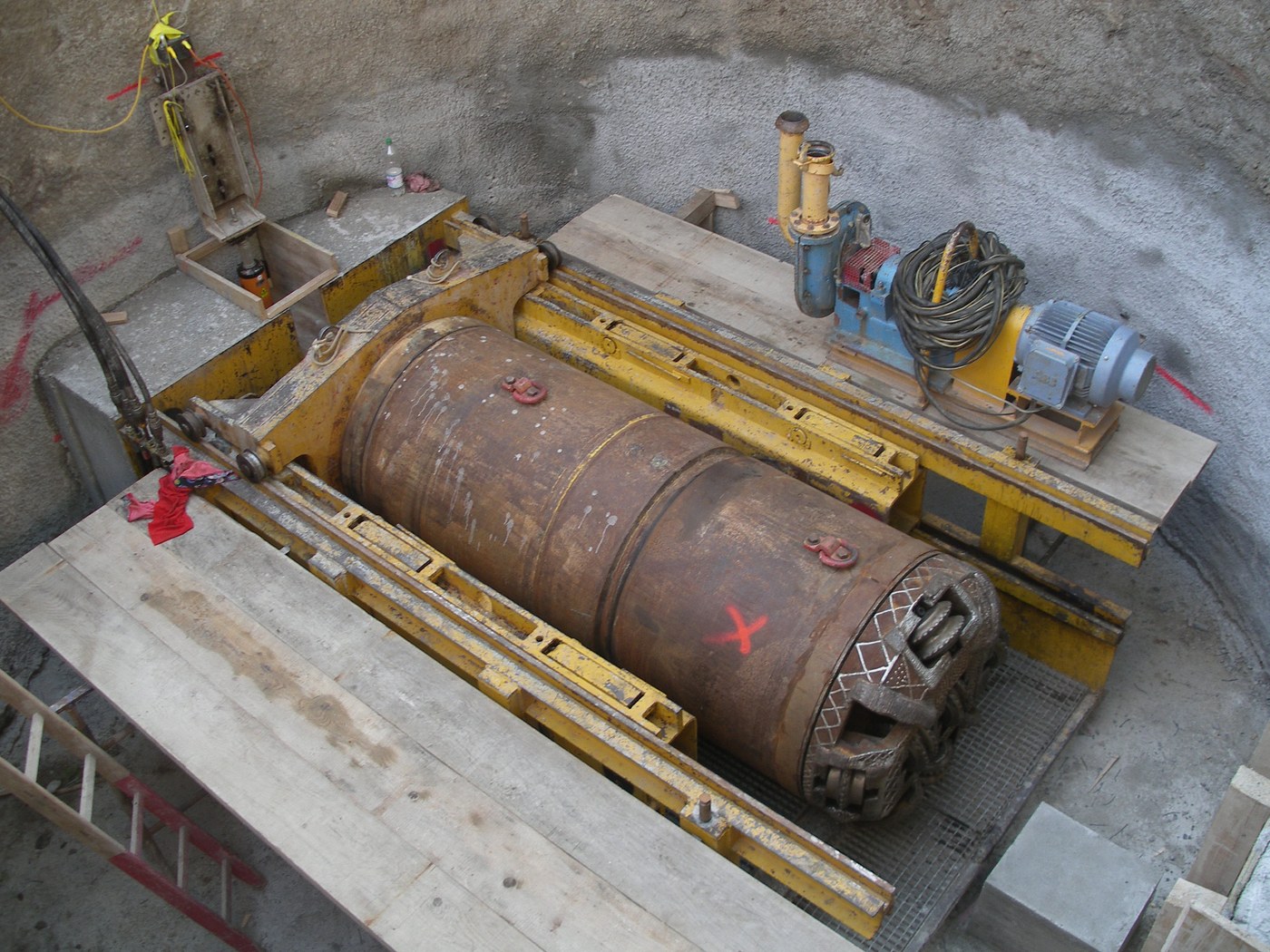 A microtunnelling machine and its cutting head on the jacking frame in a launch shaft