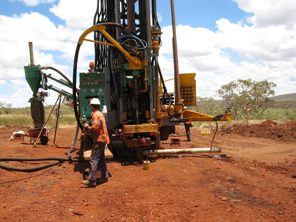A reverse circulation drill rig with its sample cyclone at a mine site
